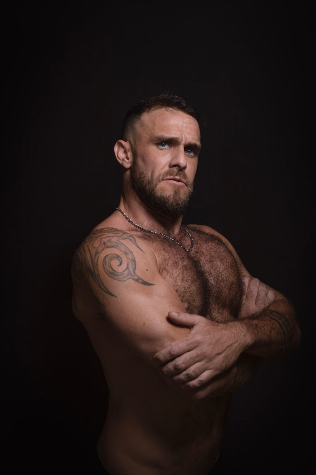 Jacques, personal trainer, standing with arms crossed